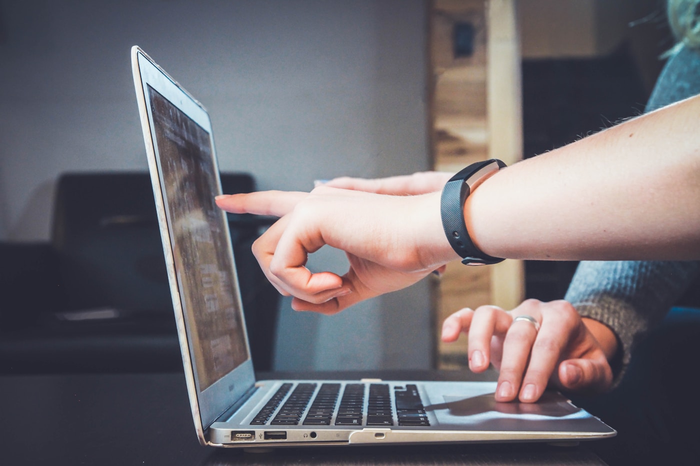 Professional reviewing AI-assisted budget work on a laptop